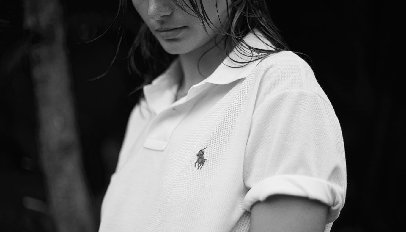 Close-up black-and-white photo of woman in The Earth Polo.