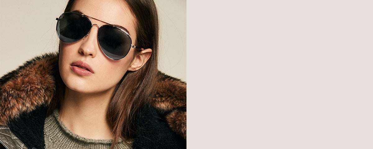 Model in dark mirrored pilot sunglasses & shearling-trim-collar jacket