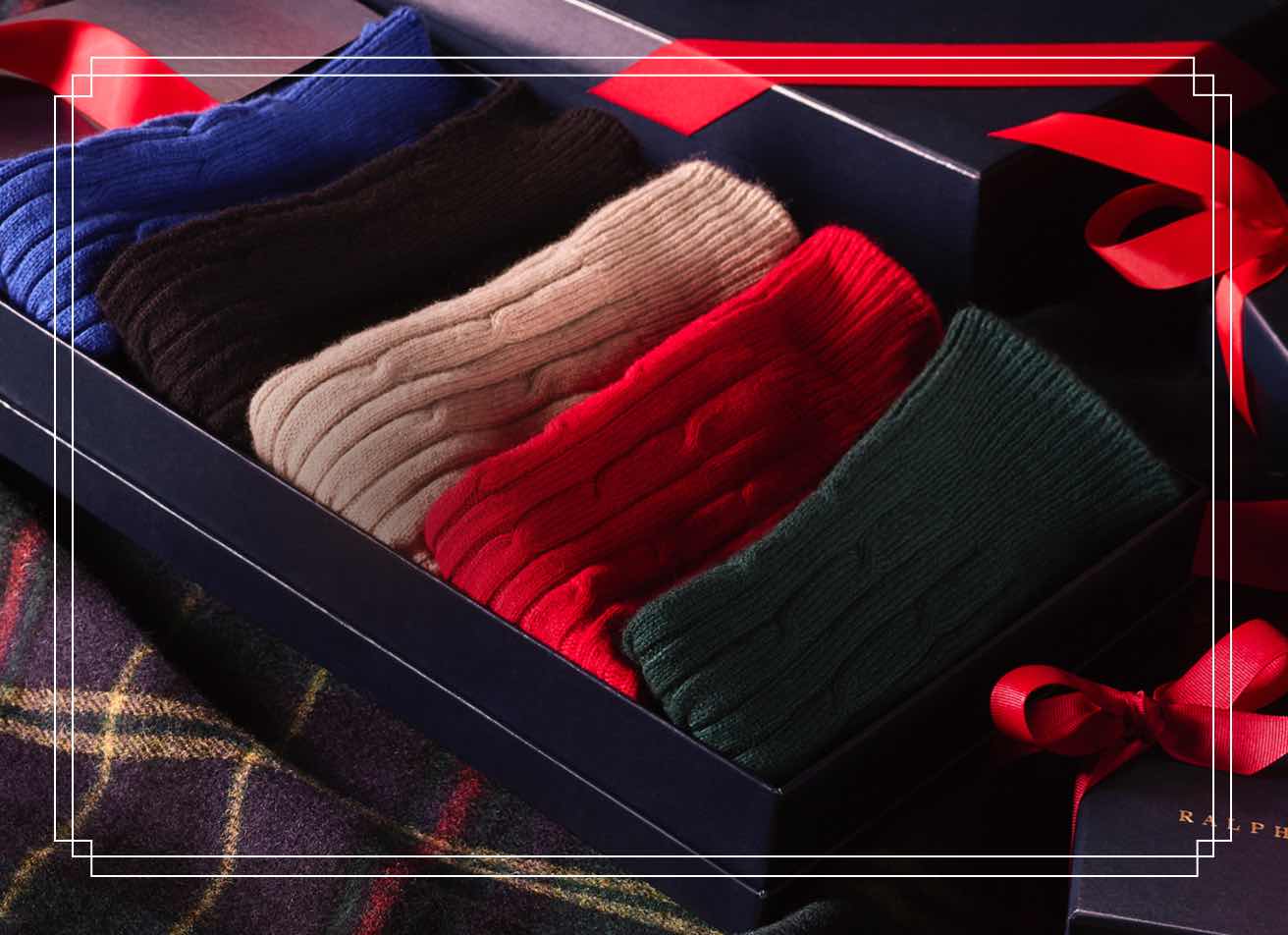 Navy gift box filled with cable-knit cashmere.