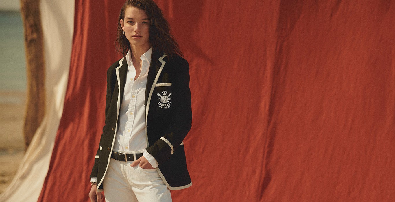 Woman in black blazer with white trim & nautical-inspired patch pocket