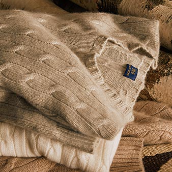 Stack of cashmere sweaters in muted winter tones