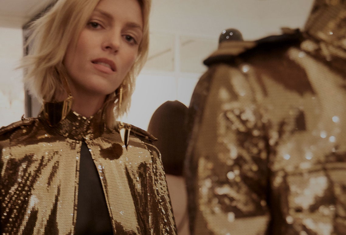 Models wearing gold-sequined jacket