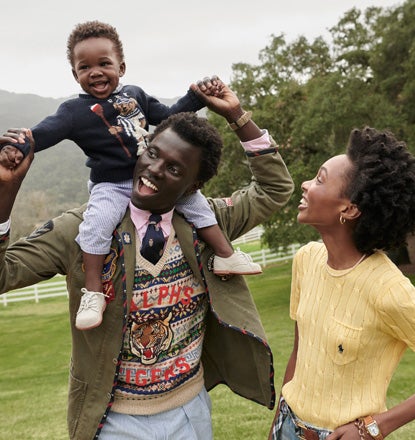 George carrying Zola on shoulders standing next to Yanii