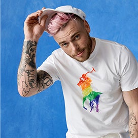 Gus Kenworthy in white tee & cap with rainbow Pony graphics