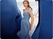 Woman in chambray dress with spaghetti straps & sweetheart neckline.