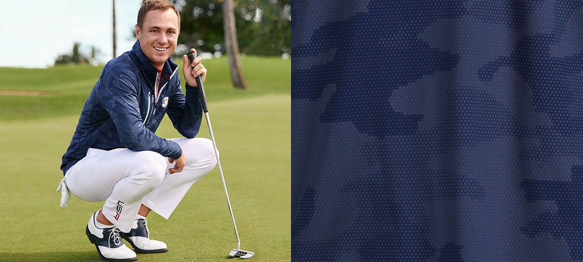 Image of Justin Thomas in white pants & navy pullover