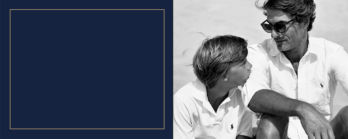 Son in white Polo shirt & Dad in white oxford on beach