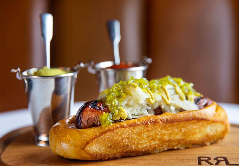 Polo Bar hot dog on wooden board.