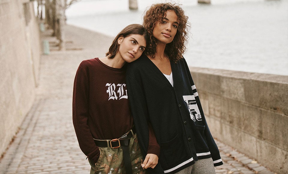 Two women in custom sweaters