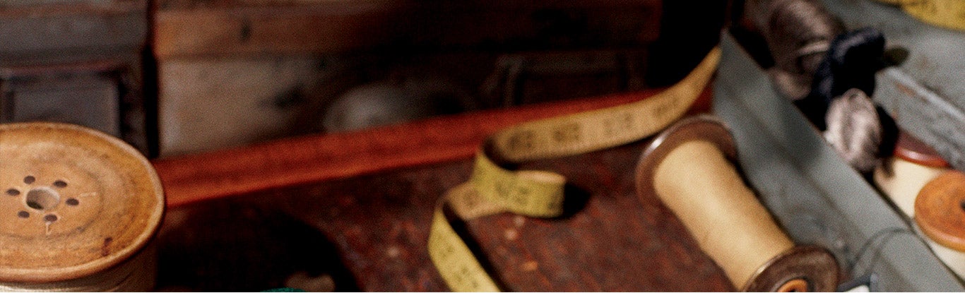 Photograph of tape measures & spools of thread