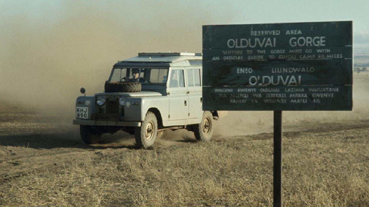 A Defender stirs up dust as it's driven near the Olduvai Gorge, in Tanzania