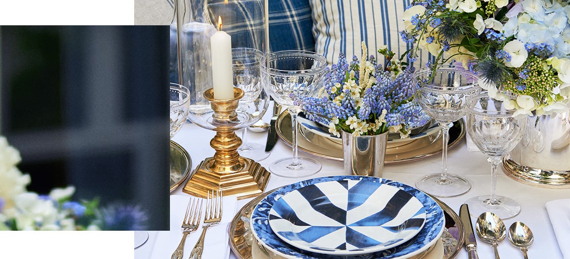Table set with stoneware plates with blue painterly stripes
