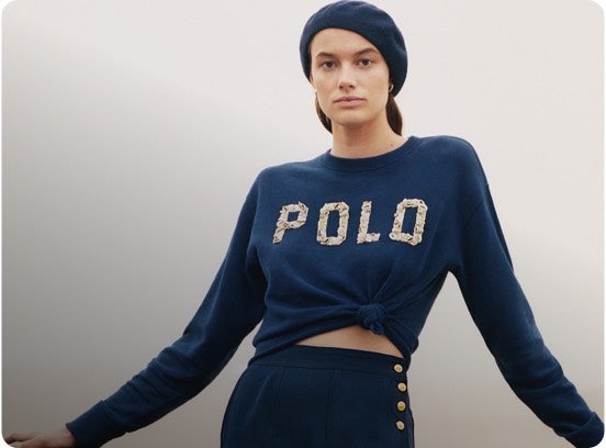 Woman in cropped blue Polo logo sweater.