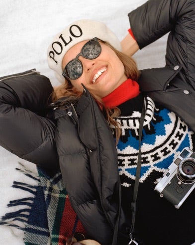 Woman in black puffer & sweater with white & blue pattern