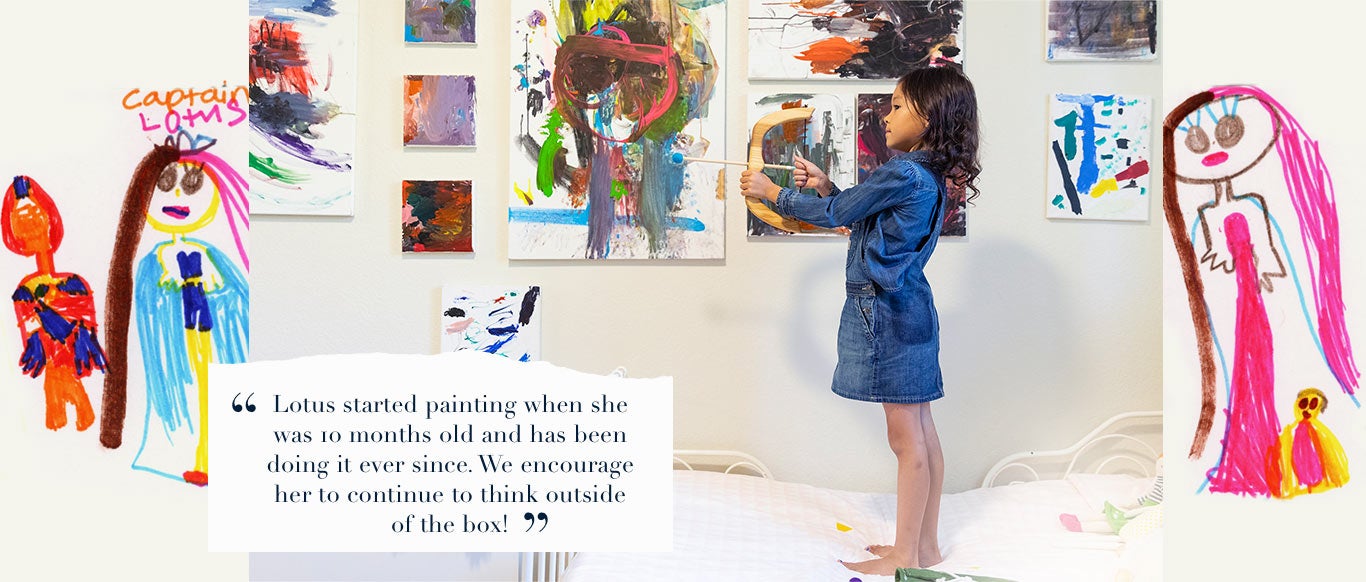 Girl in front of art wall wears long-sleeve denim shirt under denim overall dress.