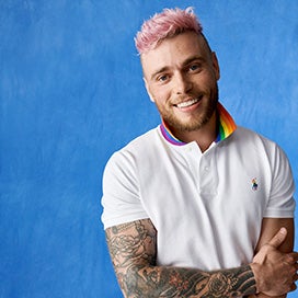 Gus Kenworthy in white Polo with rainbow collar and rainbow Pony