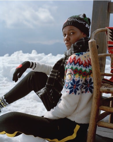 Woman in white sweater with rainbow-hued Fair Isle pattern