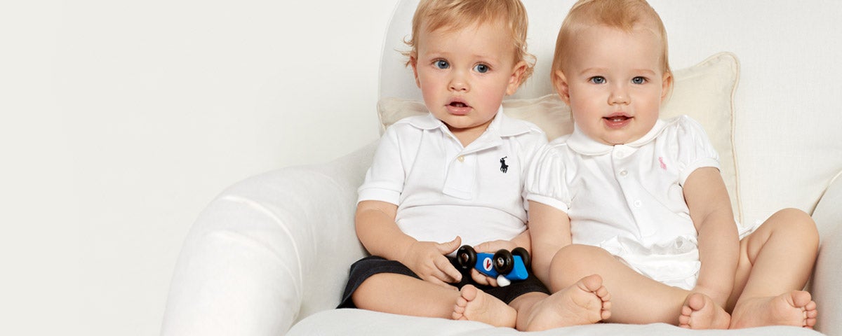 Baby boy & baby girl in white Polo shirts