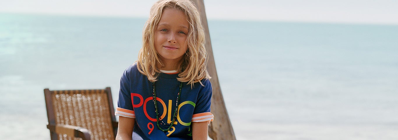 Boy wears navy Polo logo T-shirt and denim shorts.