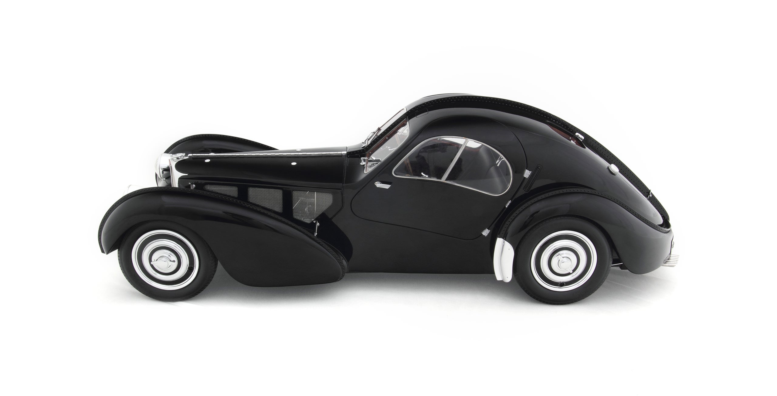 The steering wheel inside the 1938 Bugatti Type 57SC Atlantic Coupe is cut from real wood and printed with a finer grain pattern