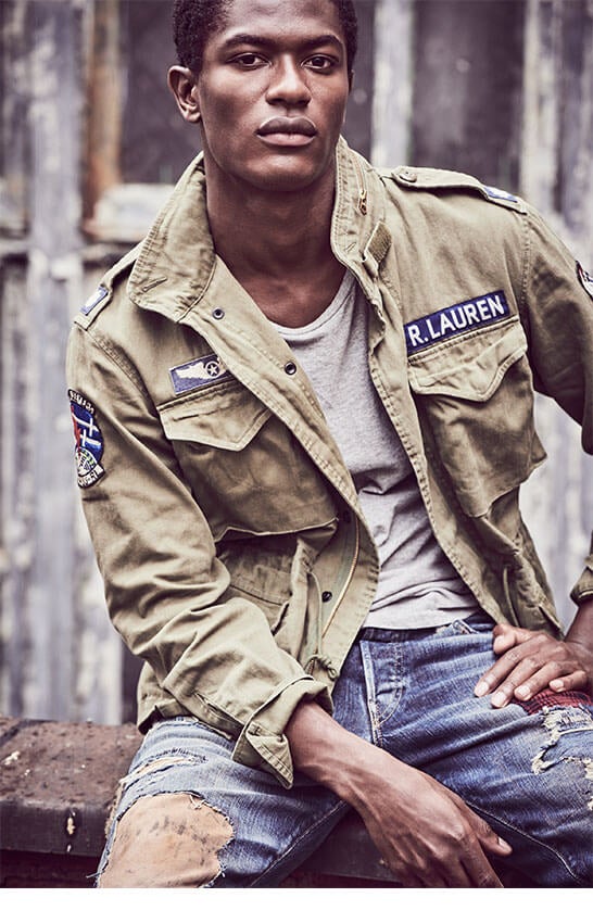 Man in army green field jacket, grey tee & distressed denim