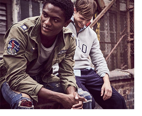 Man in army green field jacket, grey tee & distressed denim