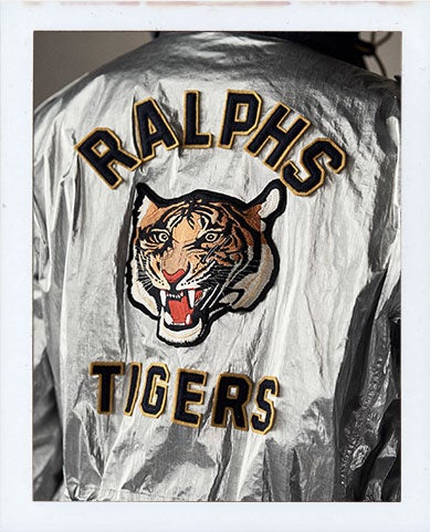 Back of metallic silver jacket with large tiger patch at back
