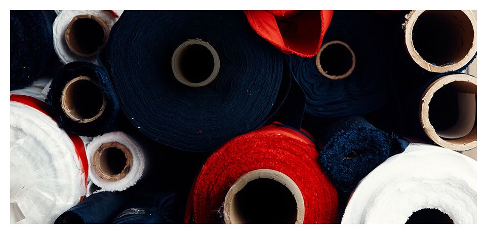 Close-up image of rolls of red, white & blue fabric