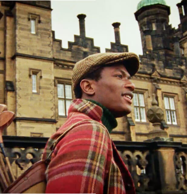 Man in red, green & yellow plaid sport coat layered over turtleneck