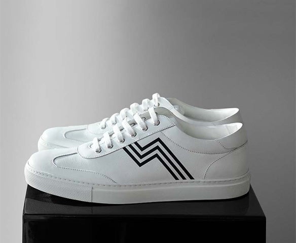 White sneakers with black racing stripe accent