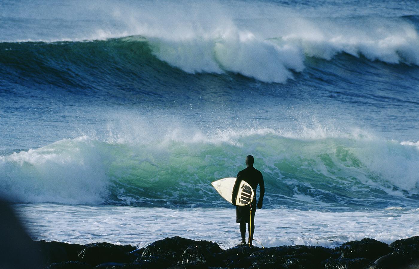                             A surfer observes the waves at Unstad. “There are these huge mountains that come straight out of the ocean,” another surfer says. “You forget that you’re even going surfing”