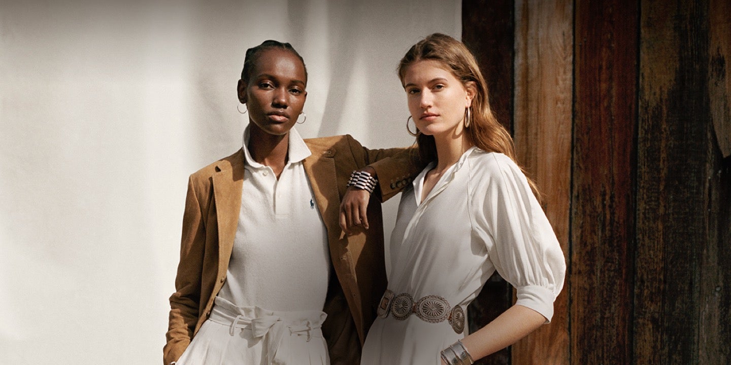 Woman in white Polo shirt & woman in white belted dress