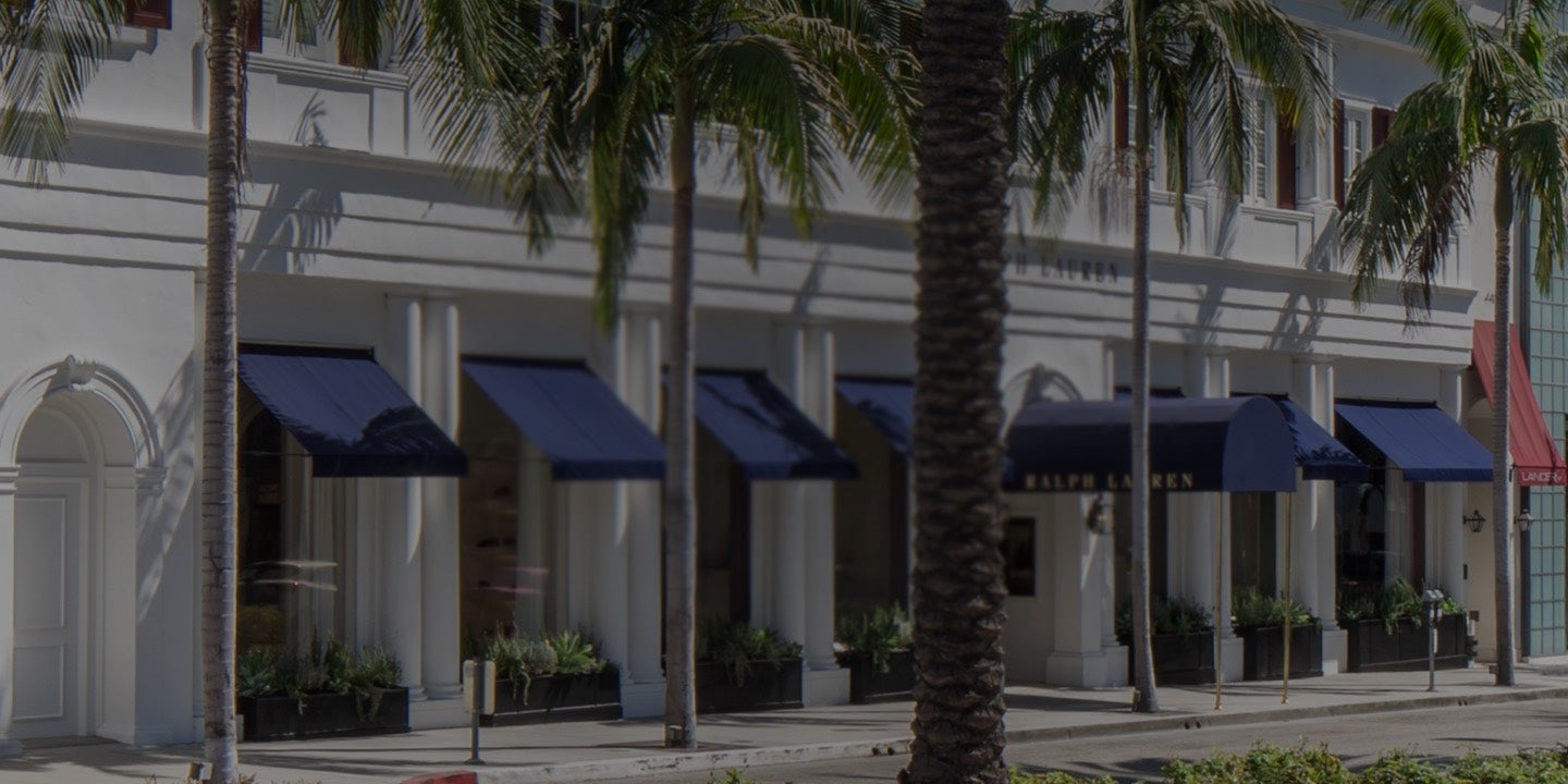 White façade of Beverly Hills flagship store with blue awnings