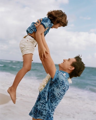 Father & son on beach in matching Hawaiian Earth Polos