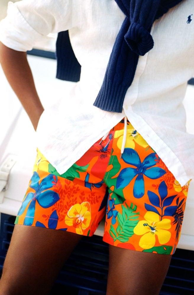 Man wears colorful Hawaiian-print swim trunks