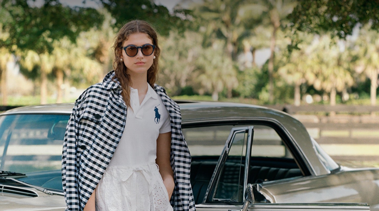 Woman in black & white gingham jacket over white Polo
