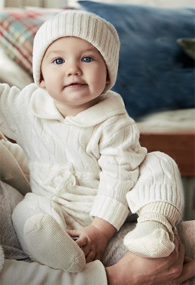 Baby in knit head-to-toe white ensemble
