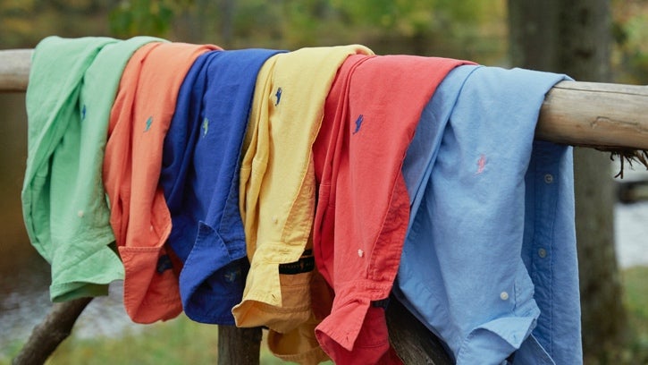 Colorful workshirts draped over fence